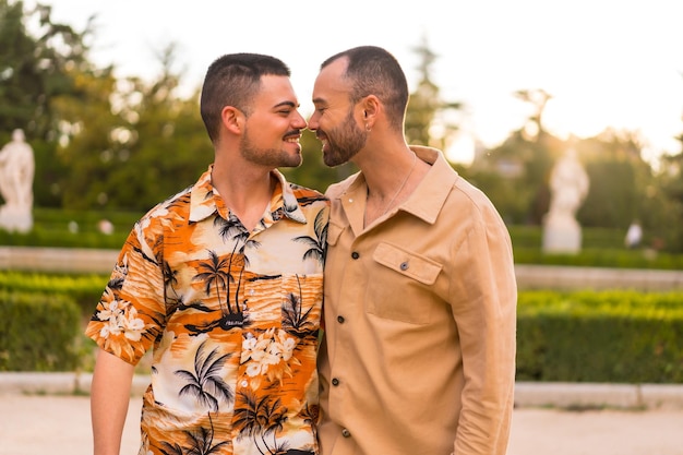 Romantic portrait of gay newlyweds walking and having fun at sunset in a park in the city Diversity and lgbt concept