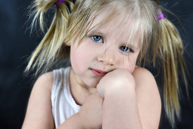 Romantic portrait of a little girl on a black background