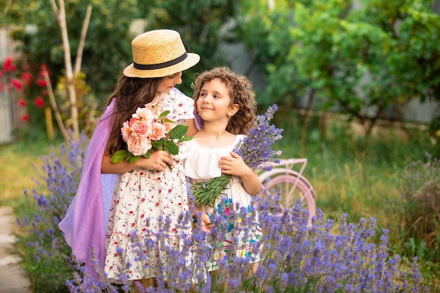 Romantic portrait o charming sisters in straw hats