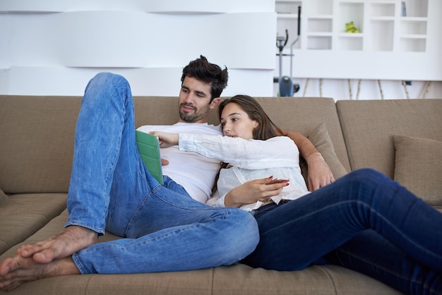 romantic relaxed young couple at modern home using tablet computer