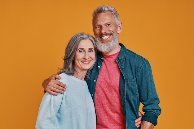 Romantic senior couple looking at camera and smiling 