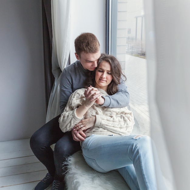 Romantic sexy couple in love having nice time together Young woman hugging boyfriend white background