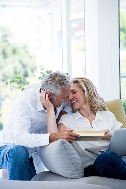 Romantic smiling mature couple with gift box