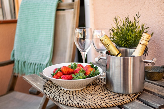 Romantic still life with champagne and strawberry on a terrace
