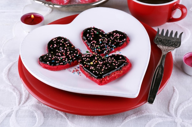 Romantic still life with cookies in form of heart on color wooden planks background