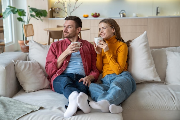 Romantic sweethearts couple spending time at home enjoying tea drink relaxing dreaming of future