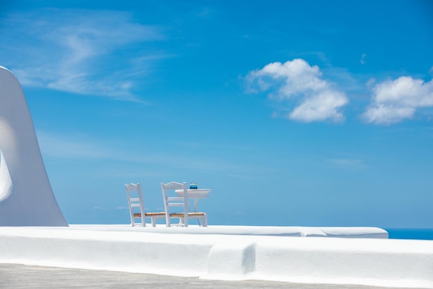 Romantic table set-up in Santorini Greece. White architecture and table for two. Love couple