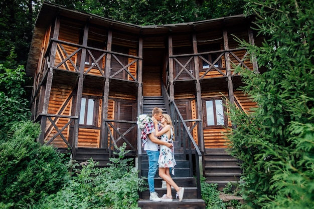 Photo romantic time. young couple stay near new house, after buying home and hugging.