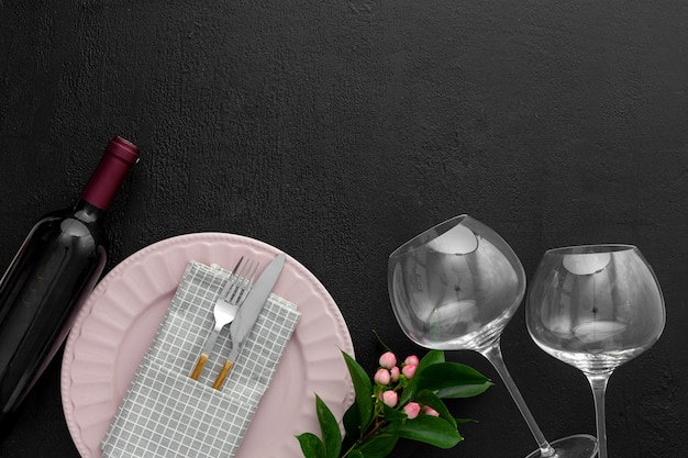 Romantic valentine's day table setting with wine, glasses and red box
