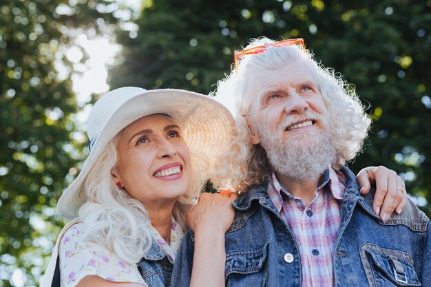 Romantic walk. Happy joyful couple being in a great mood while having a romantic walk in the park