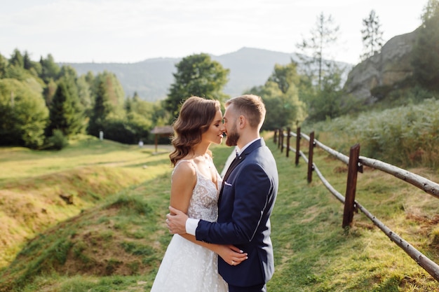 Romantic wedding couple in love walks in the mountains and forest