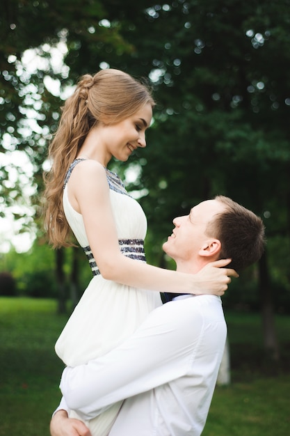 Romantic wedding moment, couple of newlyweds smiling portrait, bride and groom hug