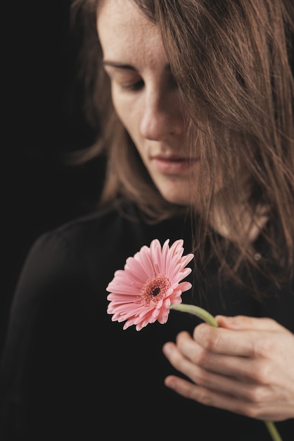 Romantic woman and beautiful pink daisy