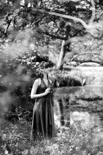 Romantic woman with long dress in park