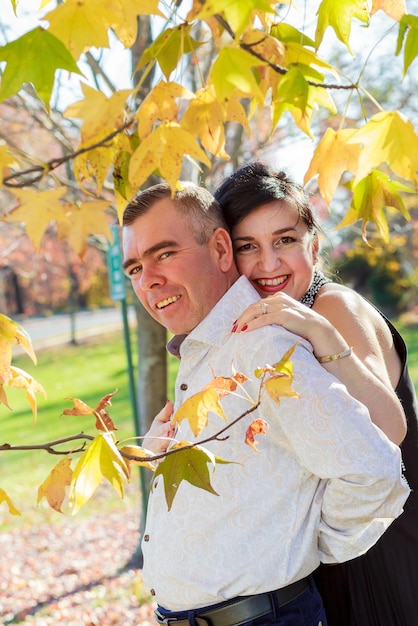 Romantic young beautiful couple walking in autumn city park