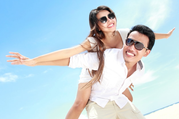 Romantic young couple on the beach having fun