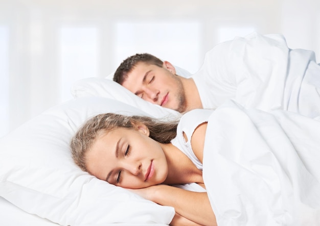 Romantic young couple sleeping in bed