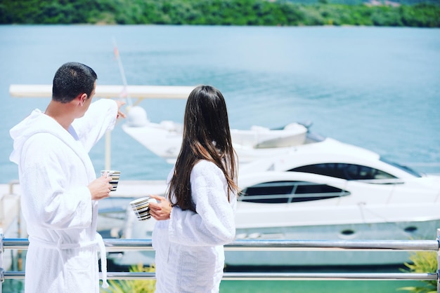 Romantic young couple spending time together and relaxing on yacht