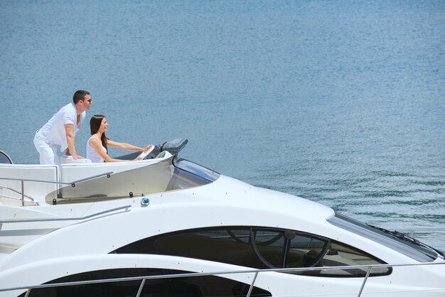 Romantic young couple spending time together and relaxing on yacht