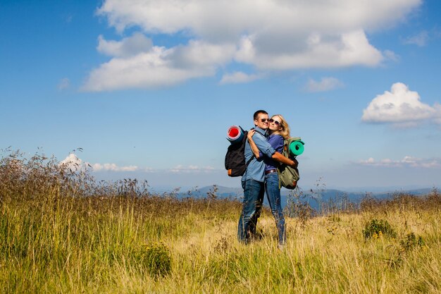 Romantic young couple while traveling in the mountains