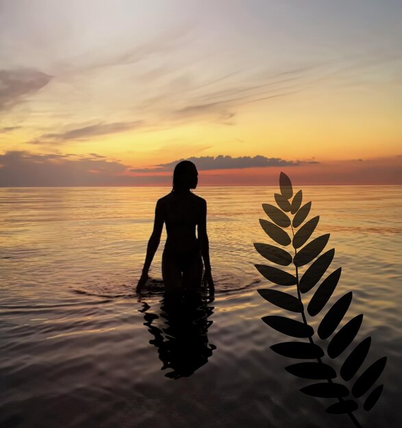 romantic young woman  silhouette at orange sunset in the sea water wave and pink cloudy sky