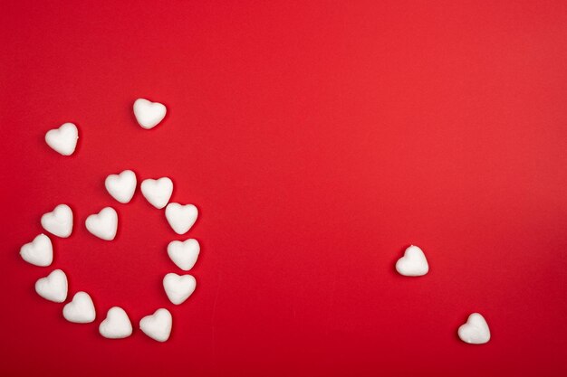 romantired background with small white foam hearts placed in a heart shape with empty space for text