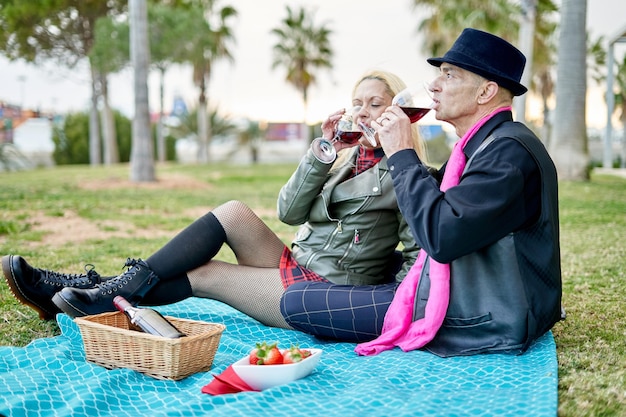 Romantisch stel van middelbare leeftijd dat genegenheid toont met wijndrank