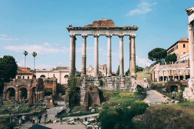 Rome, Italy - June 23, 2018: Panoramic view of temple of Vespasian and Titus is located in Rome at western end of Roman Forum. It is dedicated to the deified Vespasian and his son, the deified Titus