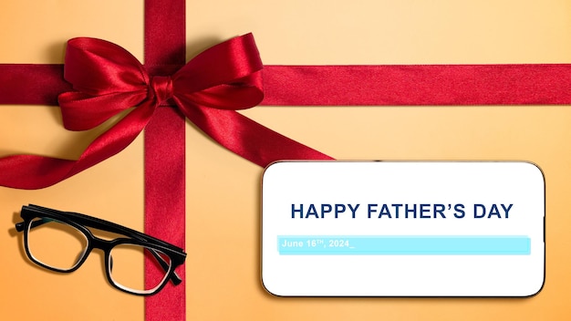 Foto rood lint en een bril met een happy fathers day boodschap