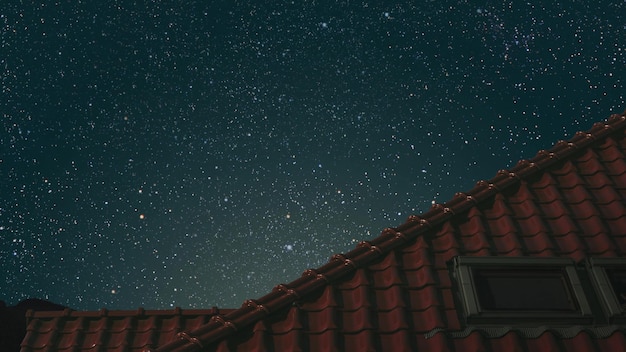 Roof of the house under the night blue sky