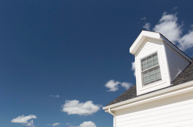 Roof of House and Windows Against Deep Blue Sky