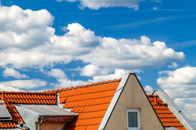 Roof of house with windows and yellow roof tiles