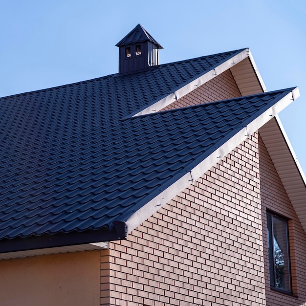 The roof is made of brown metal tiles.