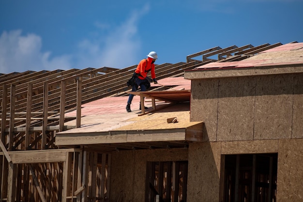 Roof repair on rooftop construction worker install new roof construction worker roofing on a large