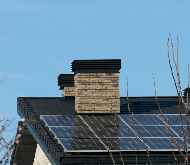 Roof of a residential building with solar panels Green energy and energy independence concept