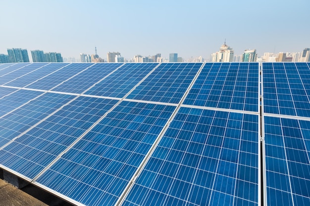 Roof solar energy panels closeup and modern city background