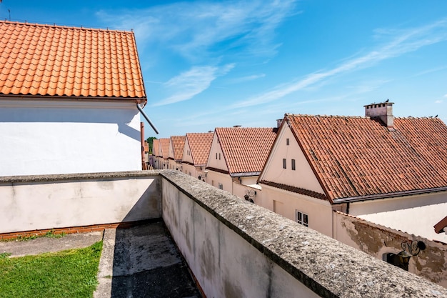 Roof tile row of stone guest houses behind the monastery wall