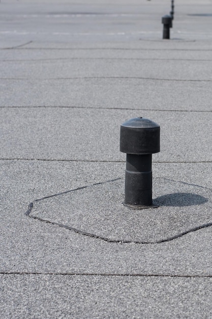 Photo roof ventilation. aerator - flat roof ventilation. roofing felt. roof ventilated.