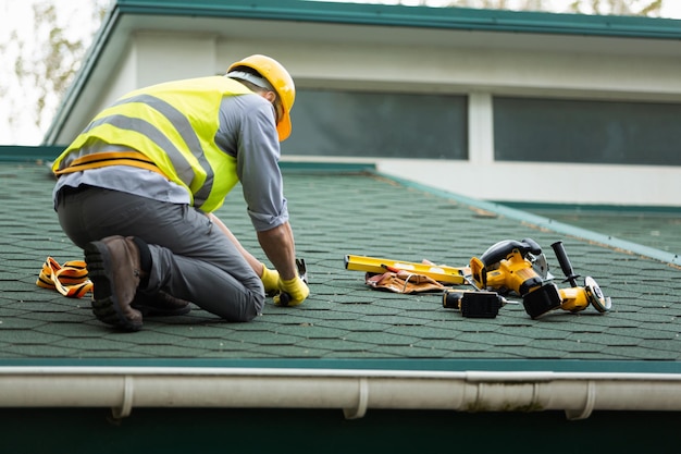 roofer working in protective work wear gloves,