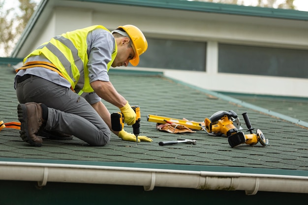 roofer working in protective work wear gloves,
