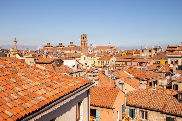 roofs of historic buildings against blue sky in Venice, Italy.