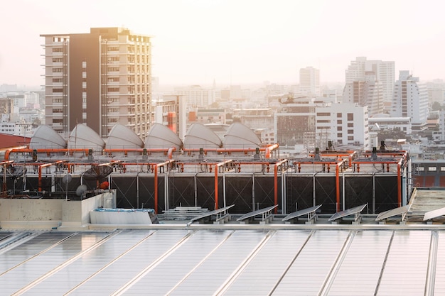 Rooftop of building HVAC Air Chillers with solar panel modern Bangkok city landscape