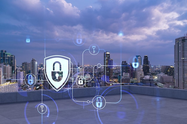 Rooftop with concrete terrace Bangkok night skyline Cyber security concept to protect clients confidential information IT hologram padlock icons City downtown Double exposure