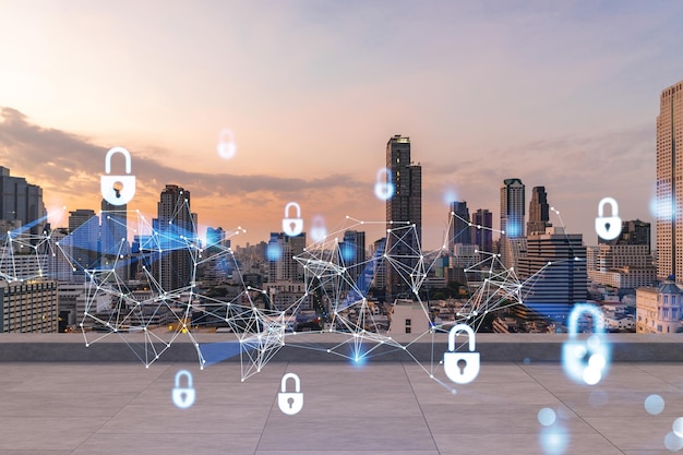 Rooftop with concrete terrace bangkok sunset skyline cyber\
security concept to protect clients confidential information it\
hologram padlock icons city downtown double exposure