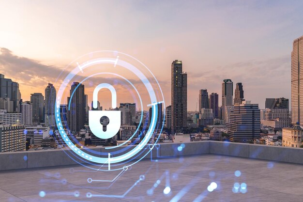 Rooftop with concrete terrace Bangkok sunset skyline Cyber security concept to protect clients confidential information IT hologram padlock icons City downtown Double exposure