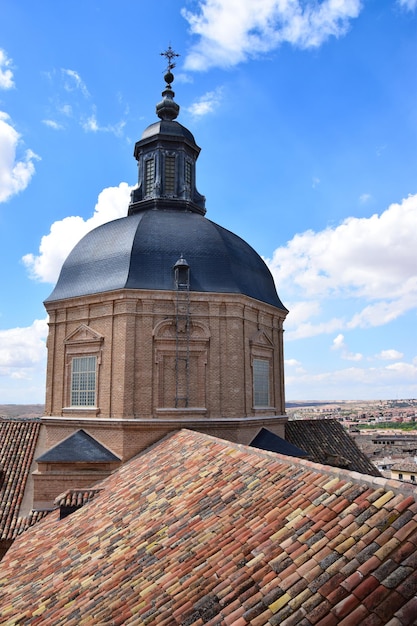 Rooftops of Toledo the ancient city, architectural buildings, blue sky and clouds