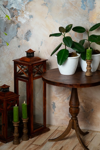 Room decor with potted plants on wooden table and lantern