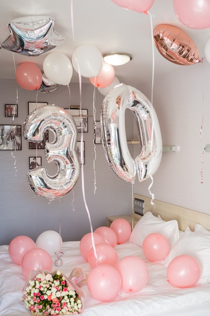 Room decorated with pink balloons for birthday, silver balloons for 30 year birthday party