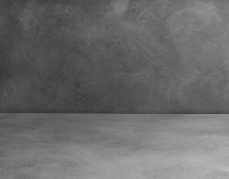 Photo the room has a cement floor and empty cement walls