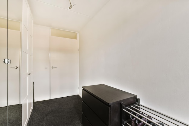 A room with a black dresser and a closet